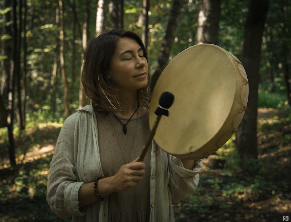 Person with a hand-drum performing Shamanic ritual